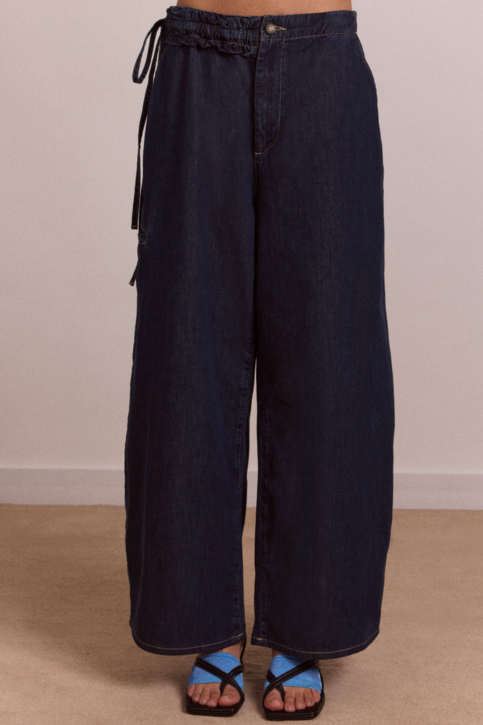 Black wide-leg pants on a neutral background