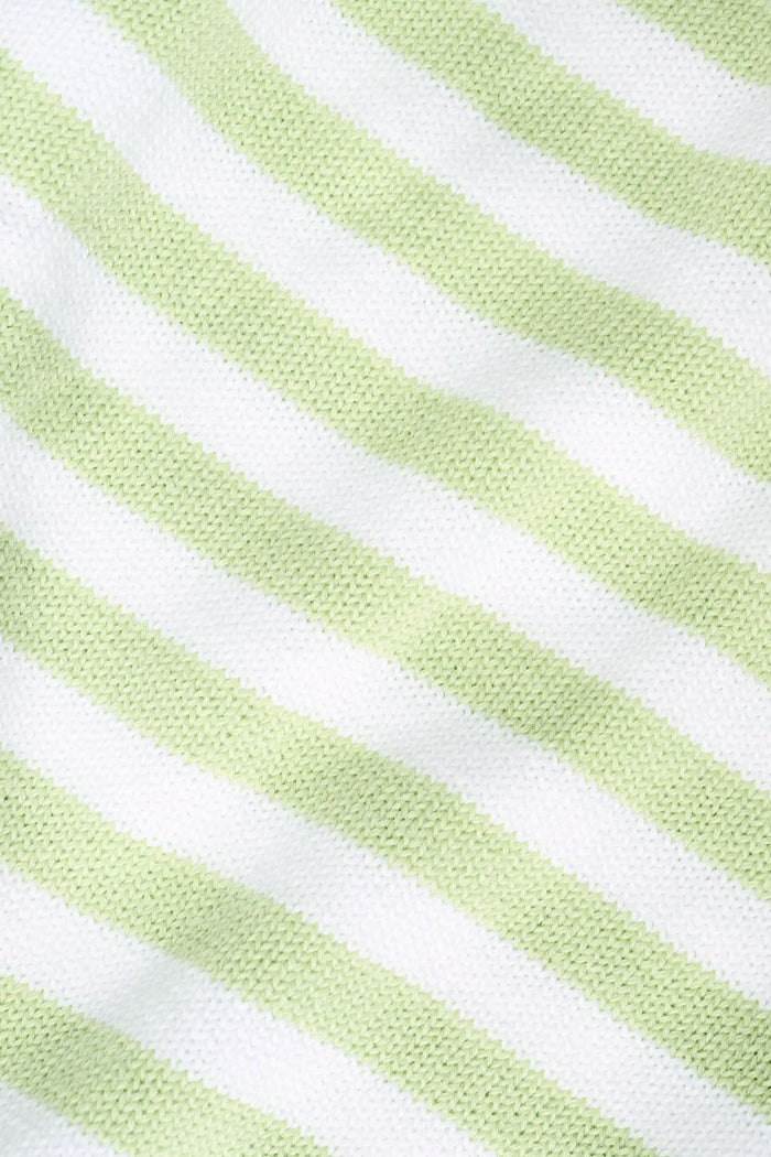 A woman with straight brown hair wears the Roller Rabbit Striped Hadley Sweater in sage green and white stripes, paired with white high-waisted pants and a beaded necklace, standing against a plain background and looking at the camera.