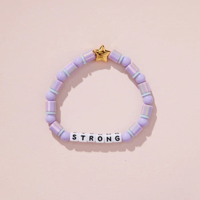 Purple beaded bracelet with a gold star tag on a pink background