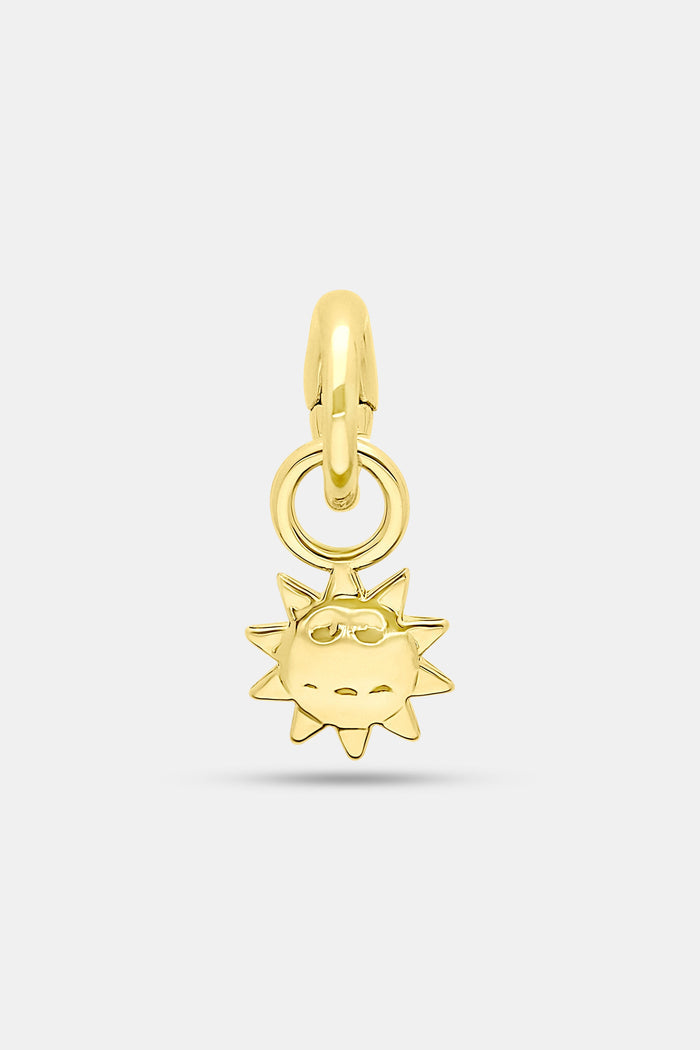 The Roller Rabbit Sun Charm features a 14K gold sun-shaped pendant with a smiling face and radiant spikes, attached to a circular gold loop—perfect for your favorite charm bar.