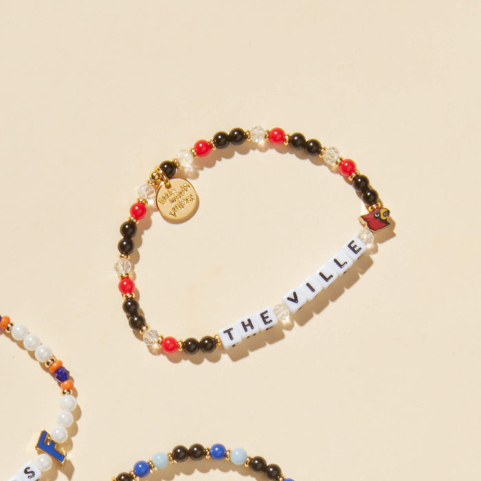 Colorful beaded bracelet with 'THE VILLE' on a beige background