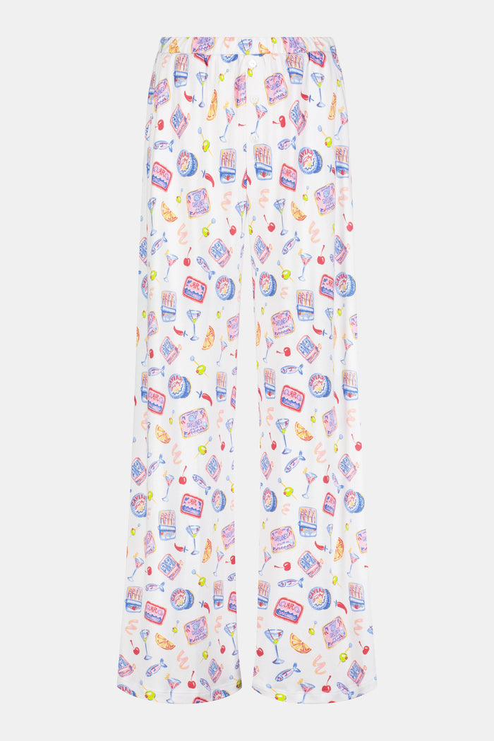 A person wears the Roller Rabbit Tinned or Twist Boden Pant, ultra-soft and white with playful prints. Their matching top complements the wide-leg pull-on pants, and they are barefoot.